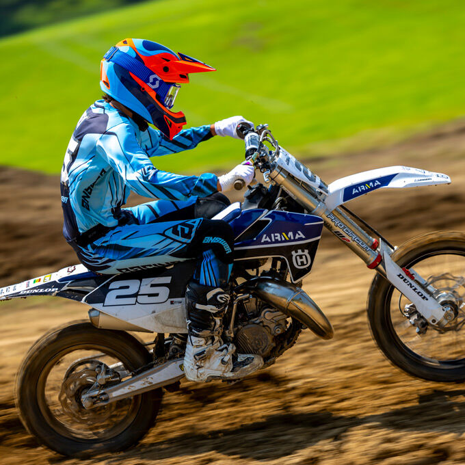 Rider wearing Bell MX-10 Mips dirt helmet while riding a motocross bike on a track