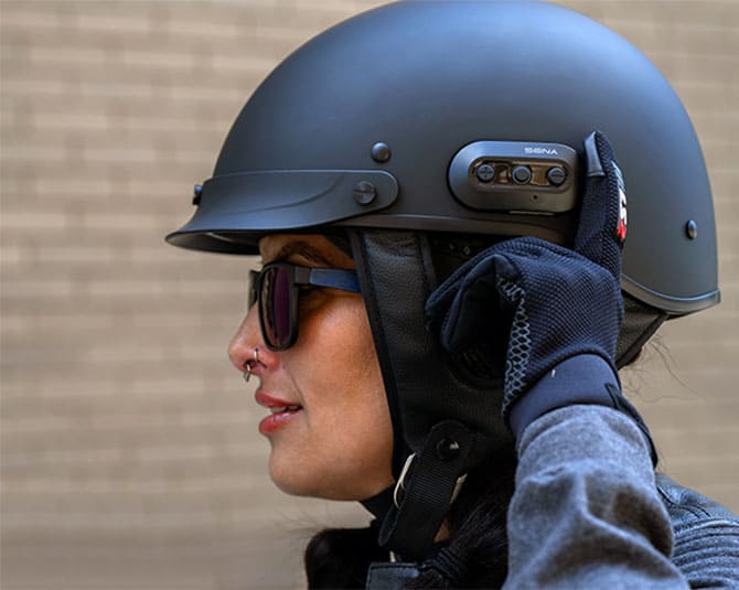 Rider wearing a Sena Cavalry 2 half helmet and using the built-in communication controls