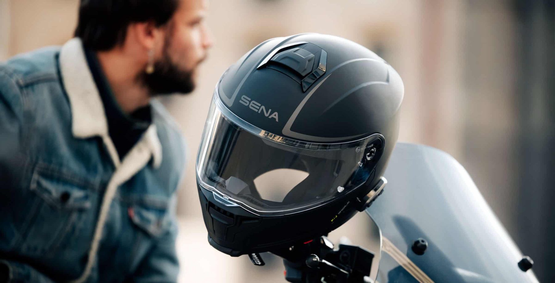 Sena Outrush 2 Mesh modular helmet with visor mounted on a motorcycle