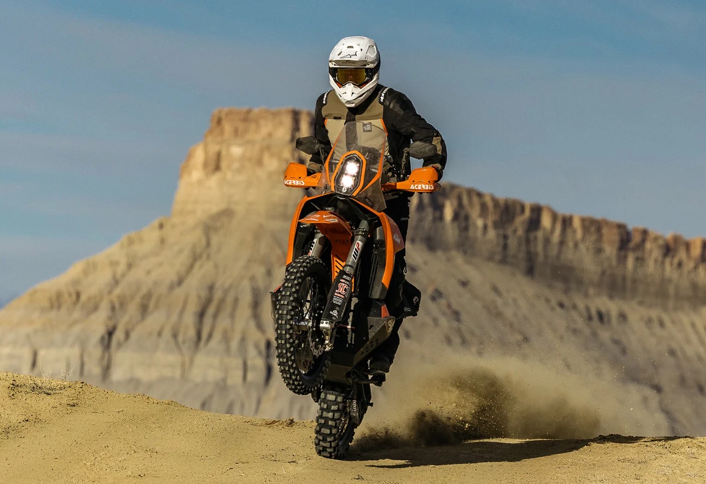 Rider wearing Alpinestars Andes Pro Drystar XF jacket riding off-road in desert terrain