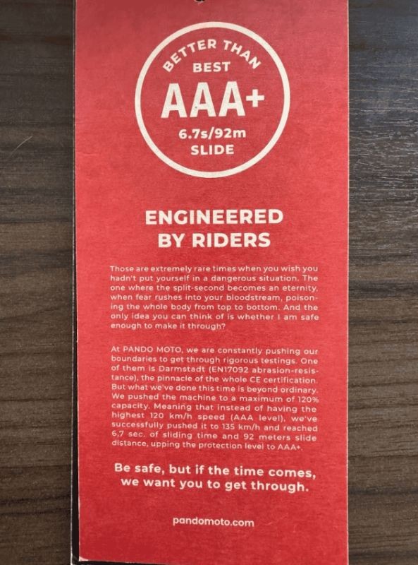 Pando Moto tag showing AAA+ abrasion rating with 6.7s slide time and 92m distance under EN 17092 test
