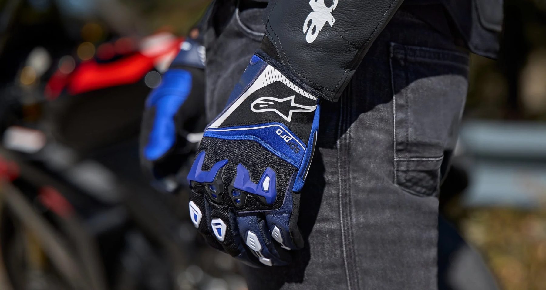 Rider wearing Alpinestars SP-R Pro gloves showing knuckle protection and flexible design