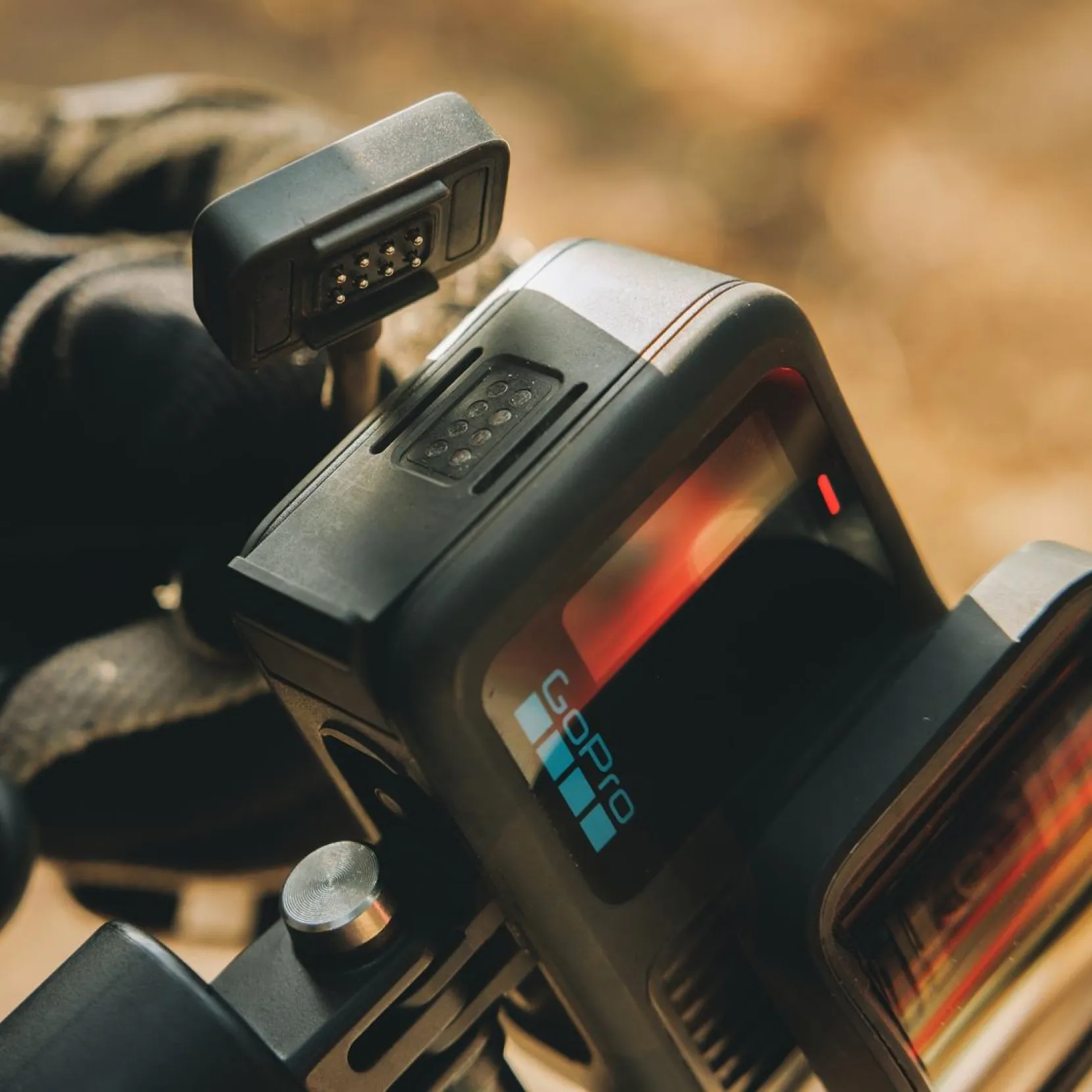 Close-up of a GoPro action camera being connected to an external power source
