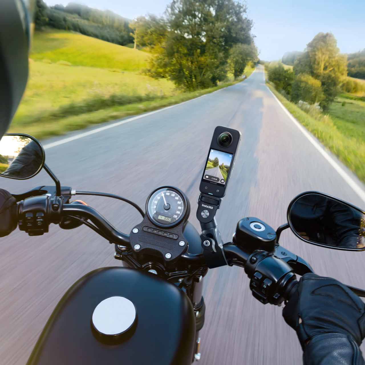Insta360 X5 mounted on a motorcycle handlebar capturing 360° road footage