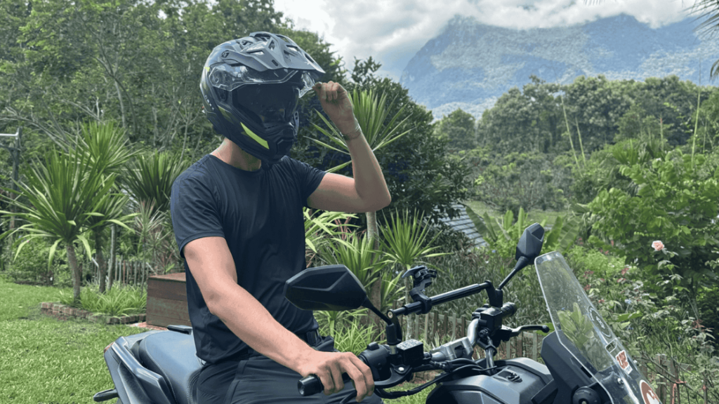 Rider wearing the NEXX X.WED 3 adventure helmet with visor up