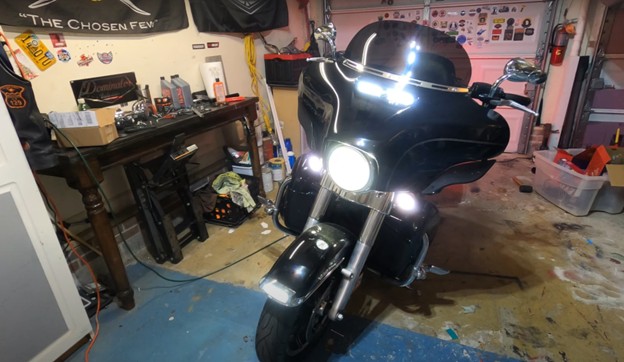 Harley-Davidson Ultra Classic touring bike with six-inch windshield and full fairing in garage setup