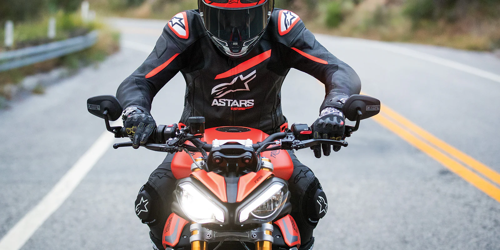 Motorcyclist wearing the Alpinestars GP Plus R V4 Airflow Leather Jacket on a twisty road