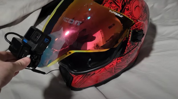 Icon Airflite helmet with GoPro mounted on the visor and mic wire visible, showing limited visor range