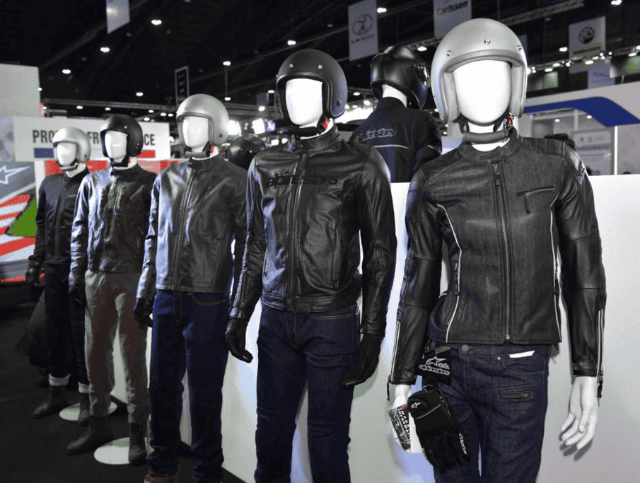 Mannequins wearing various motorcycle jackets and helmets on display.
