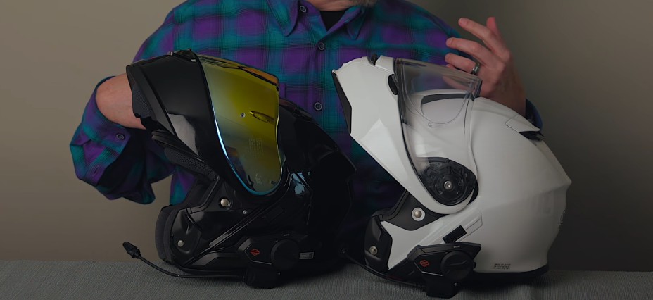 Side-by-side Neotec 3 (black) and Neotec 2 (white) with chin bars raised, showing revised shell contours