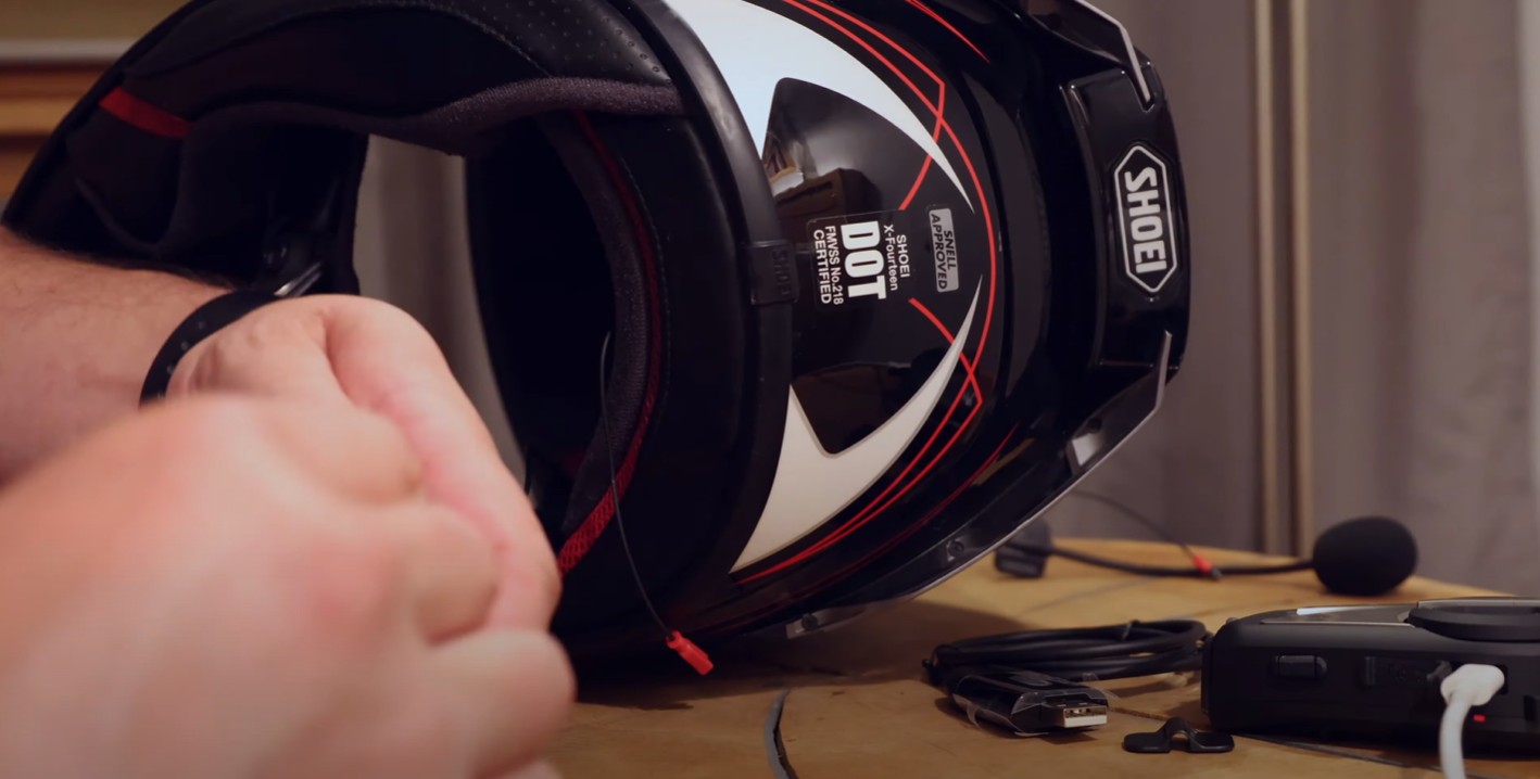 Installing the Sena 50C into a Shoei helmet with visible wiring and tools