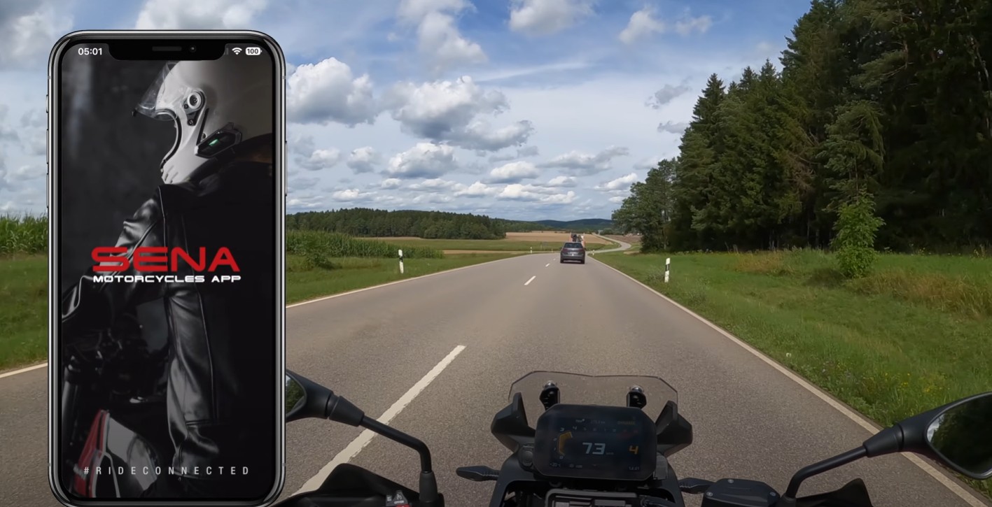 Smartphone showing the Sena Motorcycles app screen beside a motorcycle ride view