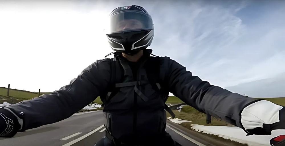 Motorcyclist wearing AGV K3 helmet on a country road during a test ride