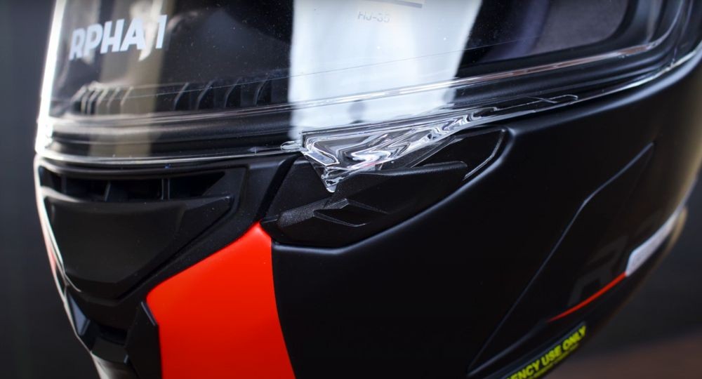 Close-up of the HJC RPHA 1N visor locking system with latch and slider