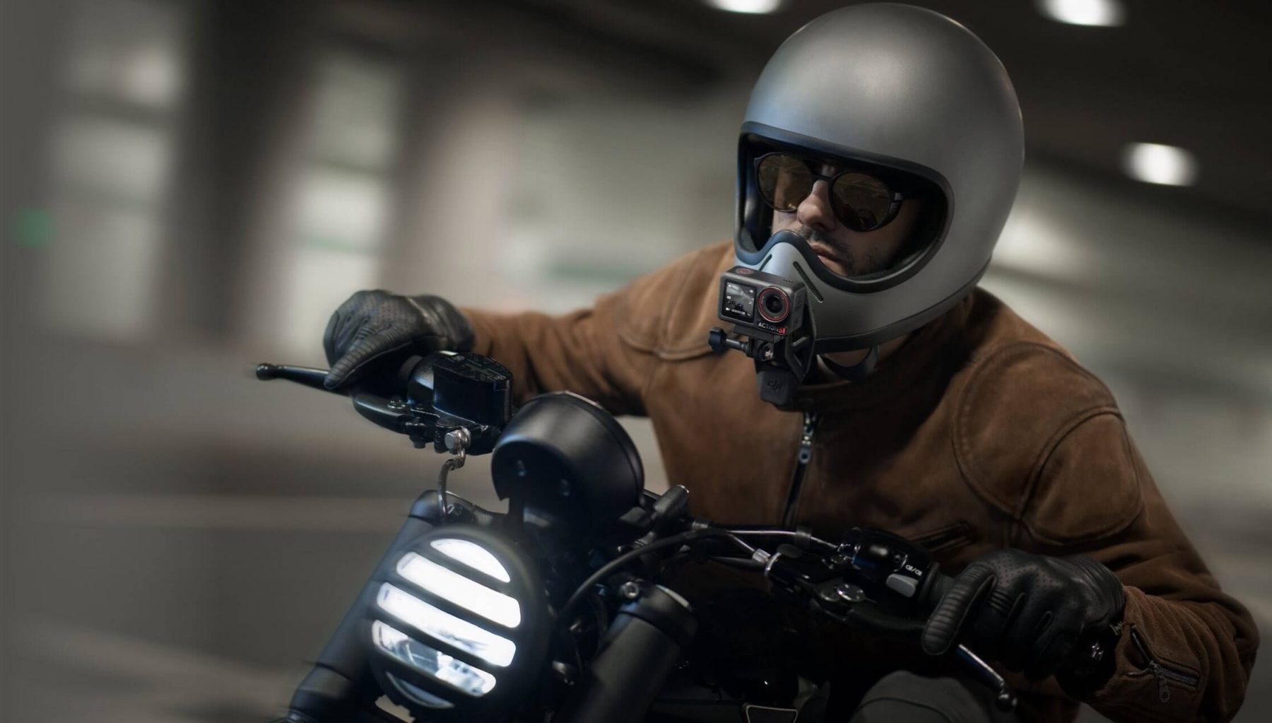 Motorcyclist with DJI Osmo Action 5 Pro mounted on helmet using magnetic chin mount