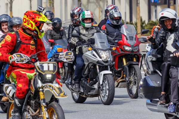Group of motorcyclists wearing mixed gear styles for commuting, sport, touring, cruiser, and off-road riding
