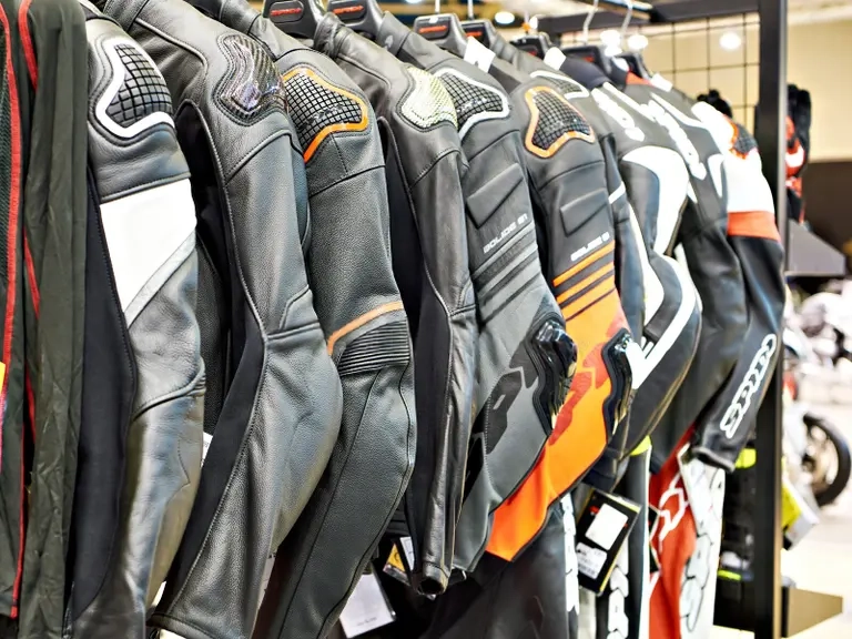 Row of armored motorcycle jackets on display in a store