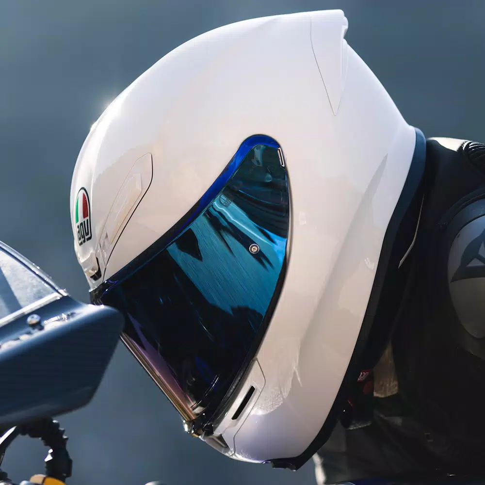 AGV K6 S helmet in white leaned into a sportbike cockpit