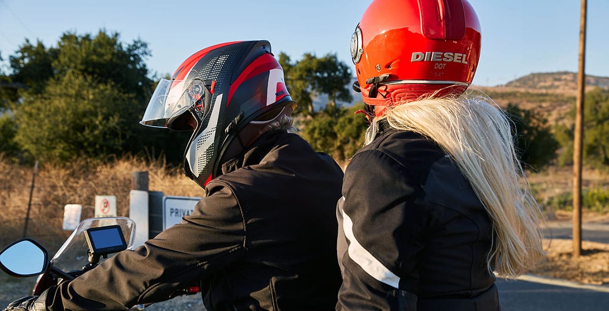 Two motorcycle riders wearing helmets, one equipped with a discreet Sena 3S PLUS headset