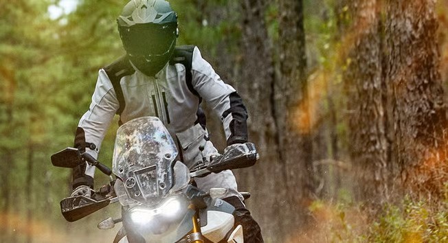 Motorcyclist riding off-road in full protective gear, wearing a Sedici adventure jacket