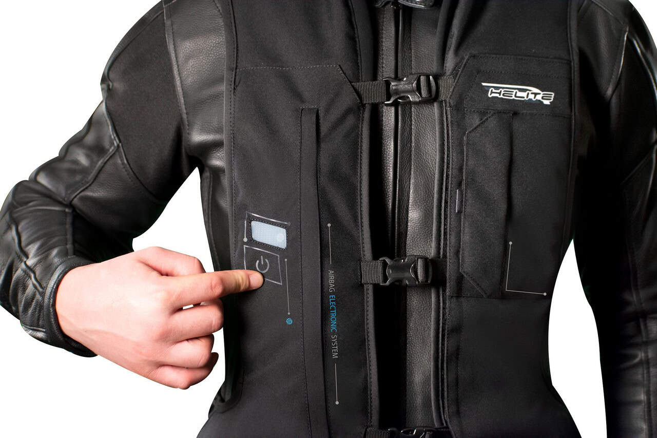 Rider powering on the Helite E-Turtle vest, highlighting the electronic system and control interface
