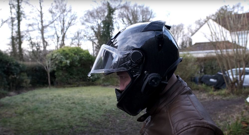 Side view of rider wearing Shark Spartan GT Carbon helmet with visor raised outdoors