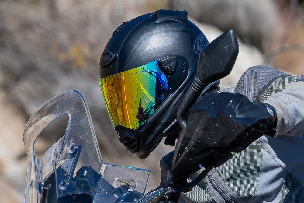 Adventure rider wearing a mirrored ADV helmet with windscreen