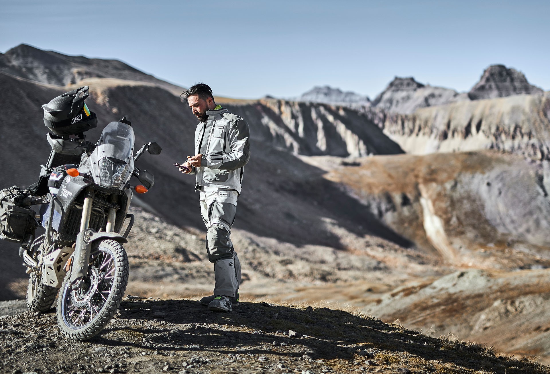 ADV rider wearing full gear navigating a narrow mountain road