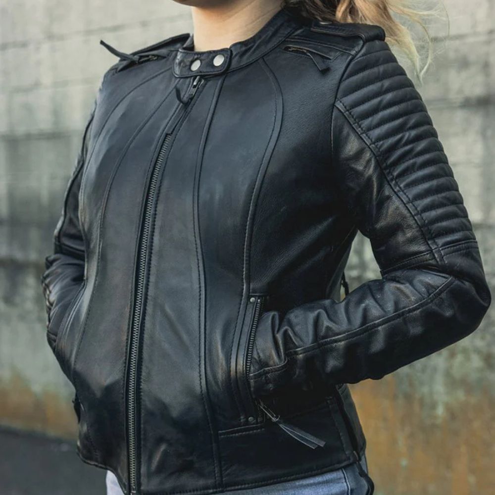 Close-up of a woman wearing the First Manufacturing Sexy Biker Jacket, showcasing its flattering fit and quilted leather sleeve details.