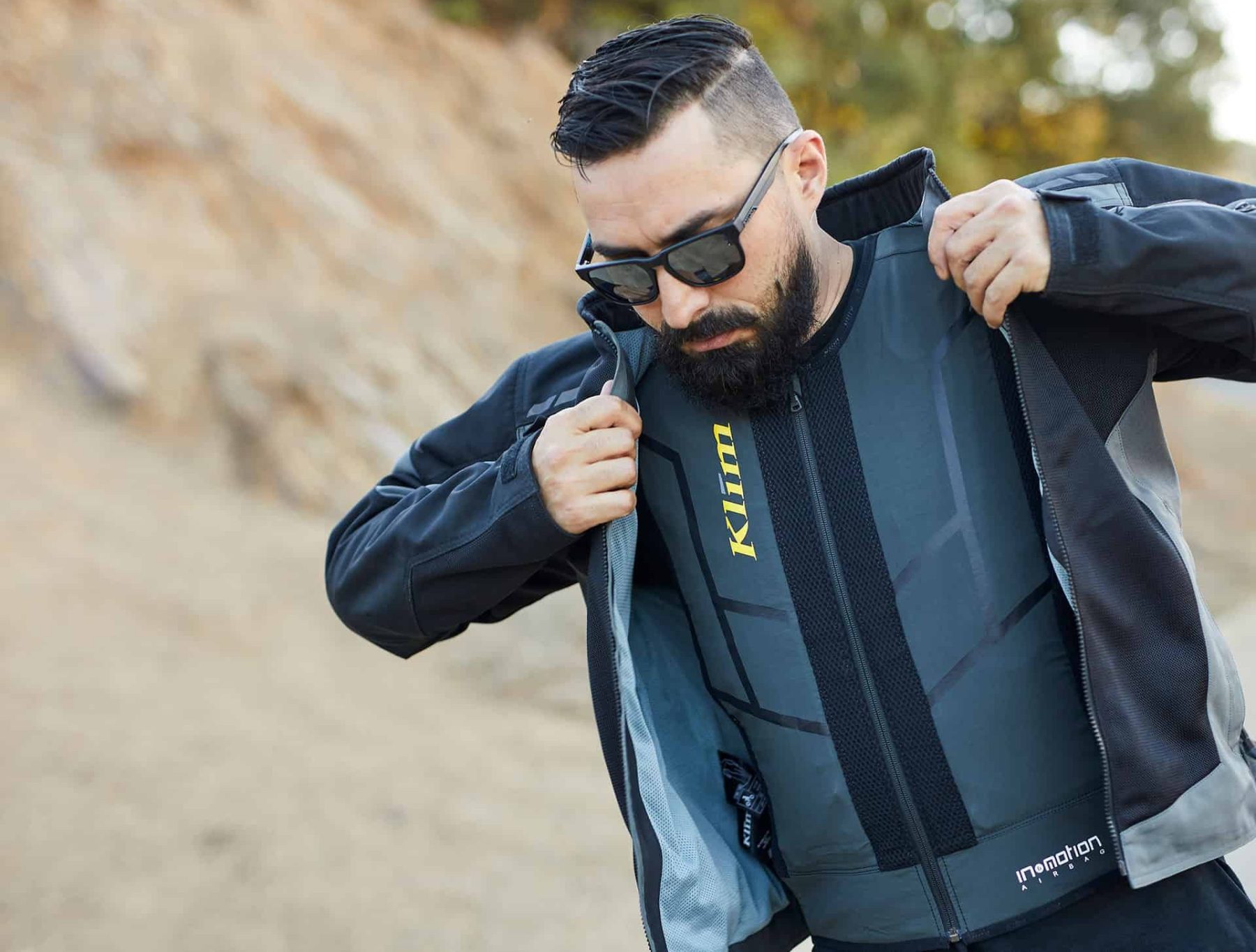 Man wearing the Klim Ai-1 Airbag Vest under a motorcycle jacket, demonstrating protective gear setup and fit.