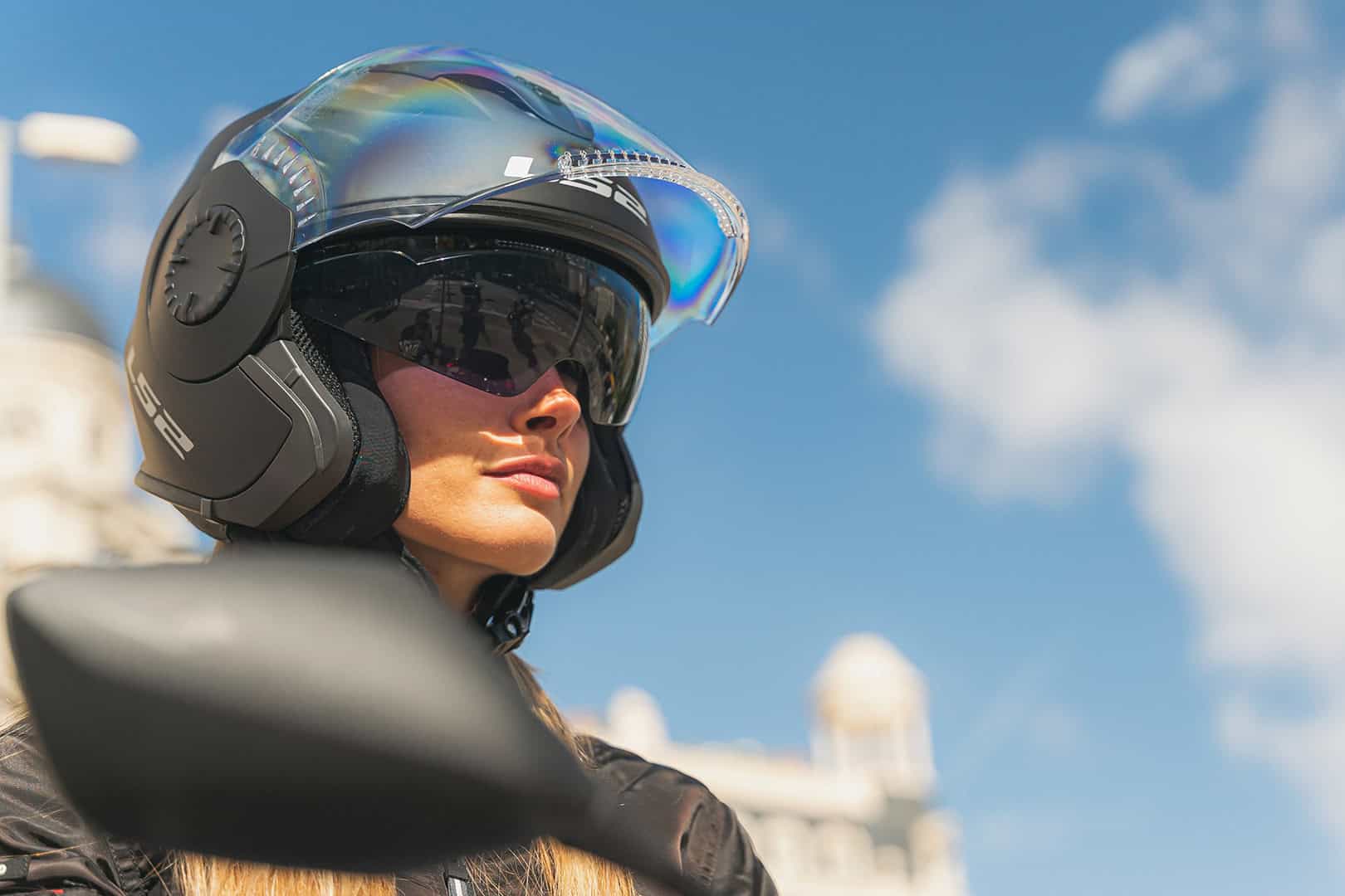 Woman wearing LS2 Verso 3/4 motorcycle helmet with face shield and sun visor in bright daylight
