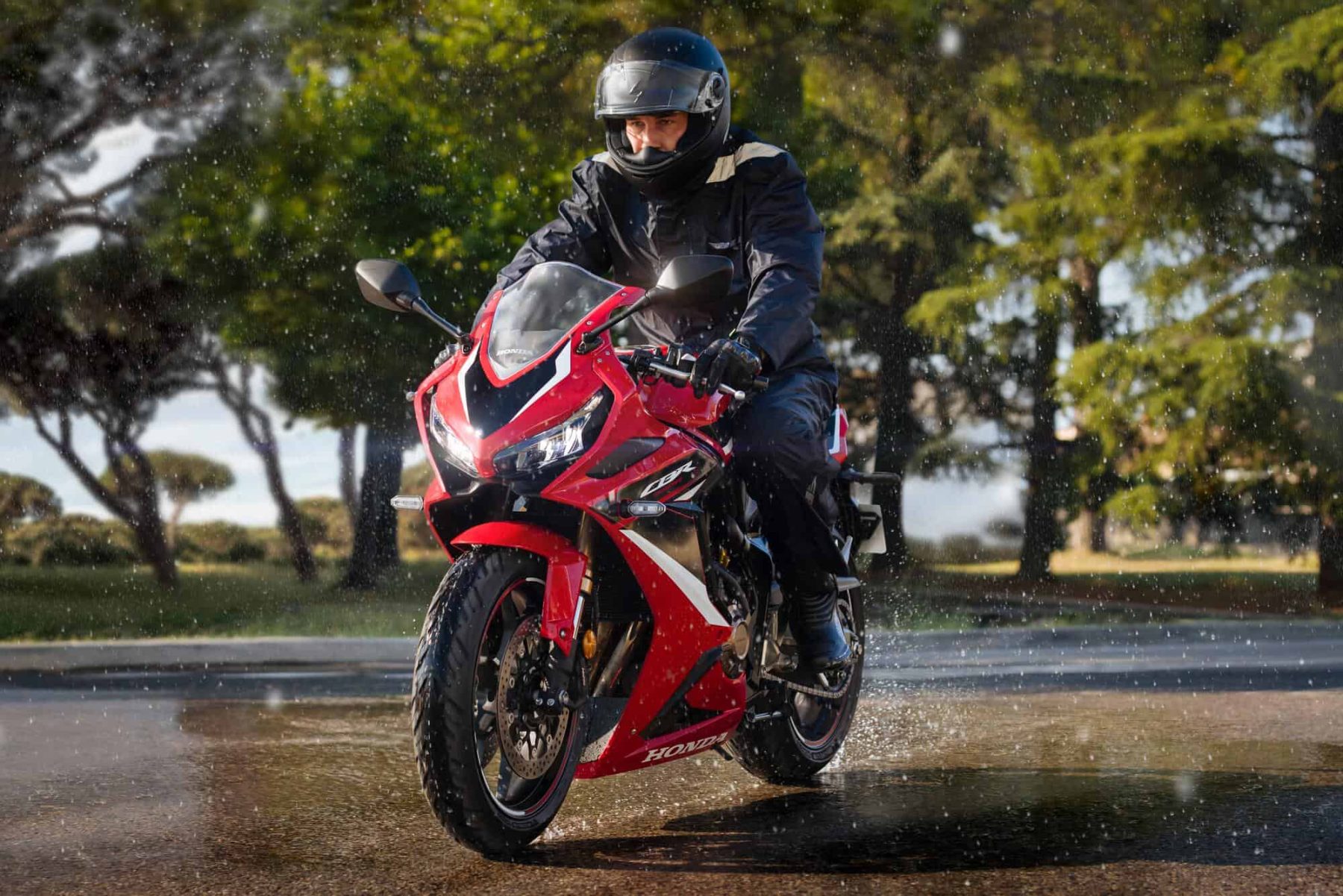 Sport-touring motorcycle riding confidently on wet road with Michelin Road 6 tires