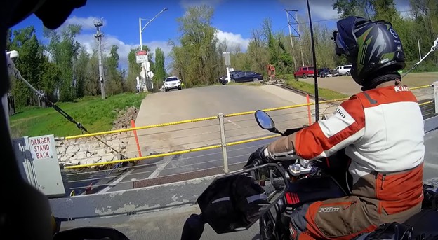 Rider wearing Schuberth E2 helmet on motorcycle without windshield