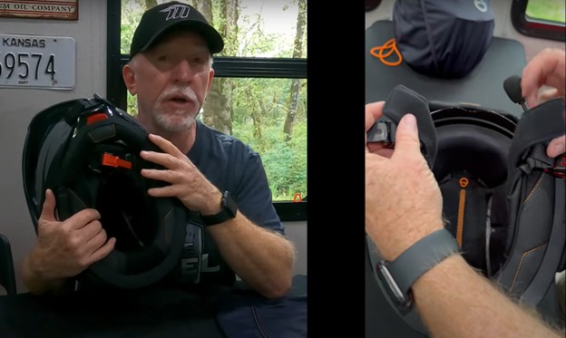 Rider holding and demonstrating the interior fit of the Schuberth E2 helmet