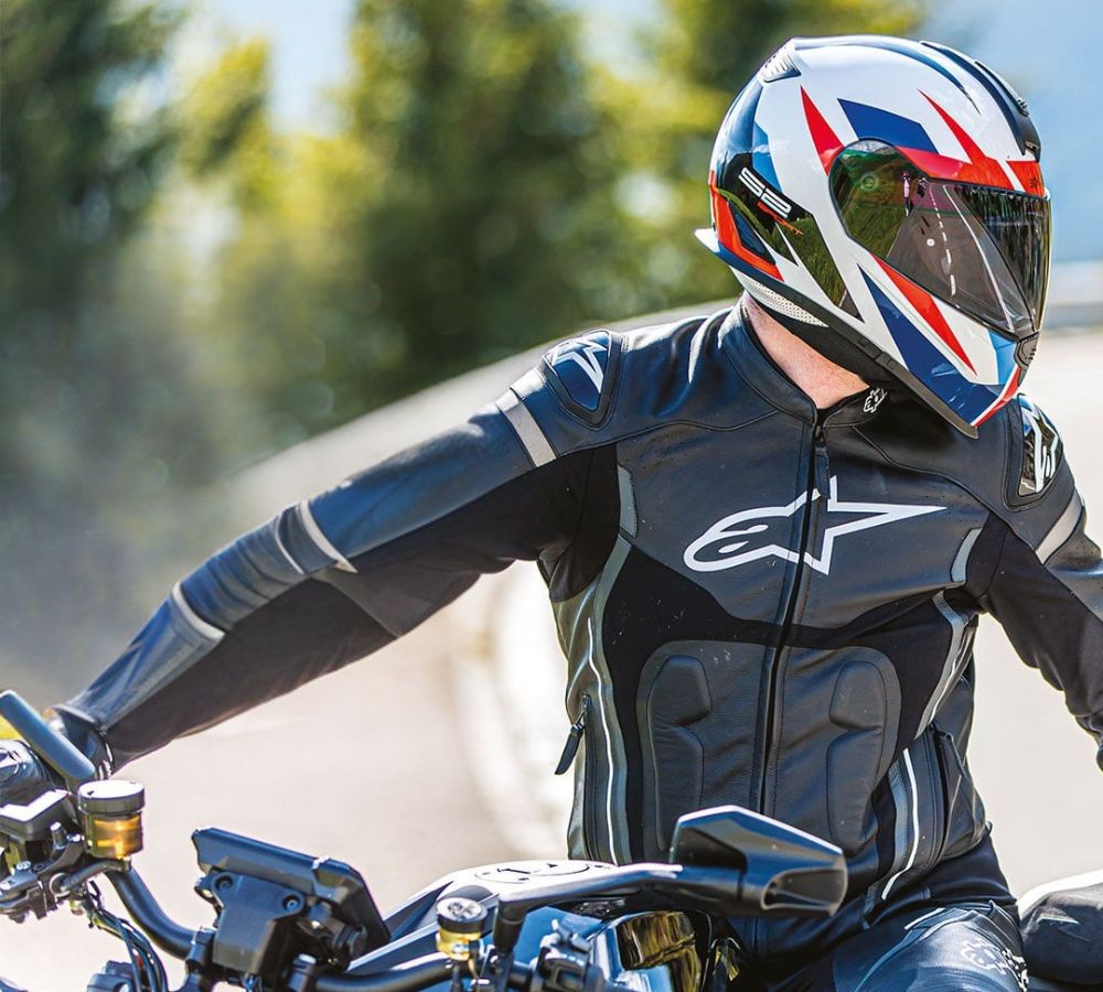 Rider wearing the now-discontinued Schuberth S2 helmet on a sportbike, viewed from the side