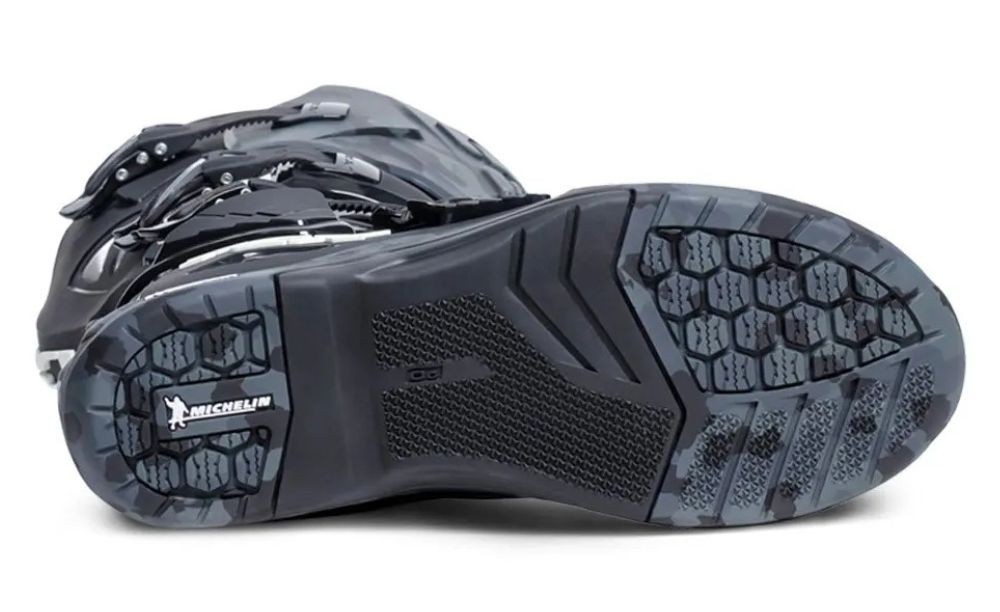 Close-up of an enduro boot’s Michelin-branded sole showing aggressive tread pattern and grip zones designed for traction on rough terrain.