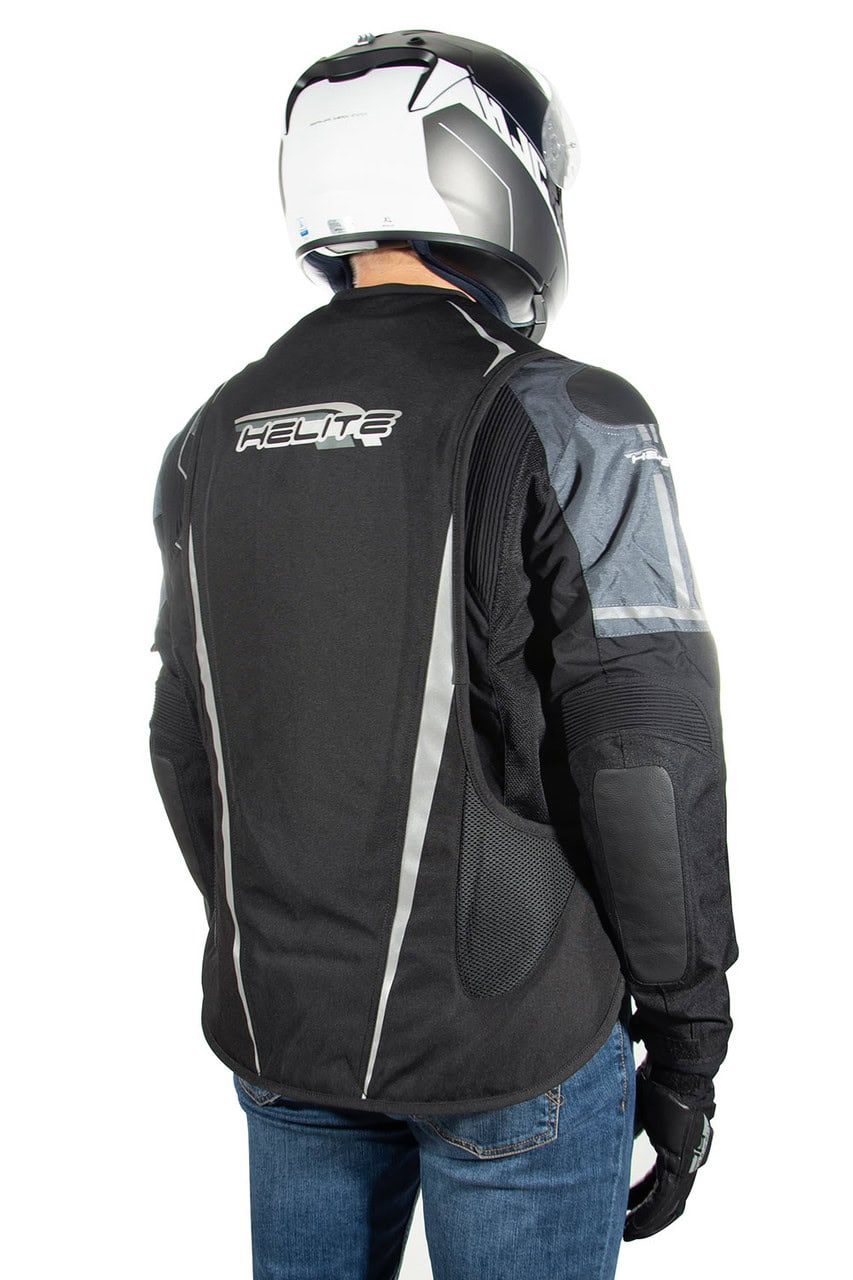 Rear view of a rider wearing the Helite Turtle airbag vest, showing built-in back protector coverage.