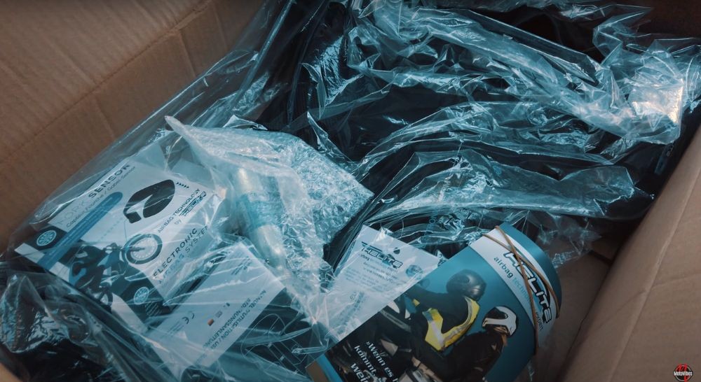 Unboxing contents of the Helite E-Turtle vest, including fork sensor and CO2 cartridge