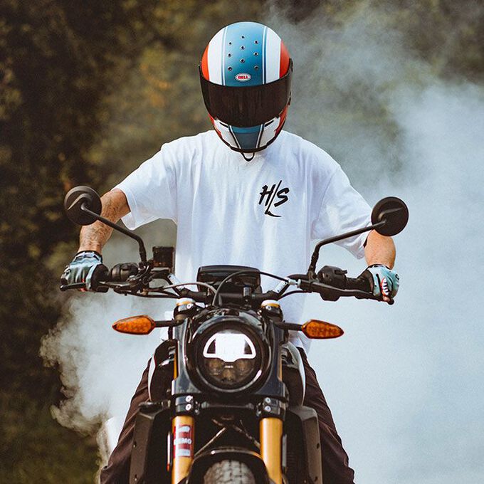 Motorcyclist wearing a Bell Eliminator helmet performing a burnout