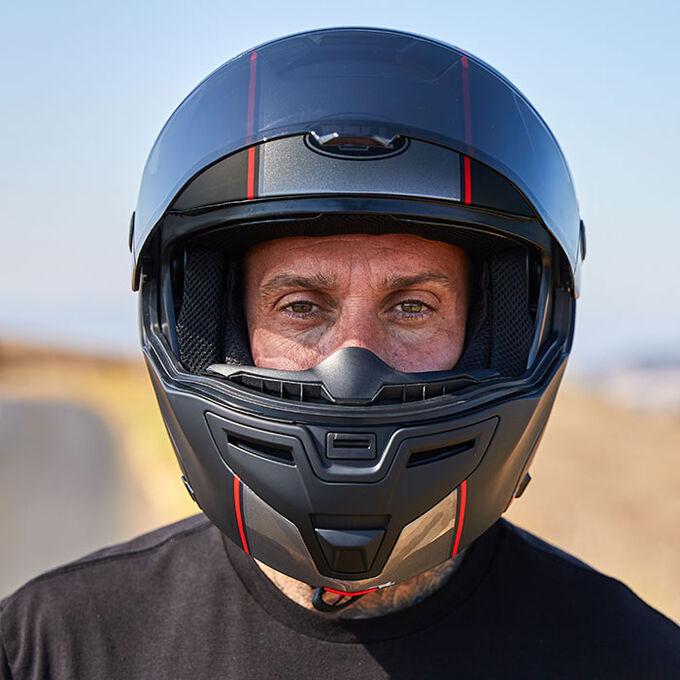 Rider wearing Bell SRT Modular Helmet on a scenic road