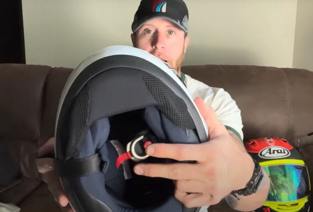 Close-up view of the Arai Corsair X interior showing double D-ring strap and inner padding