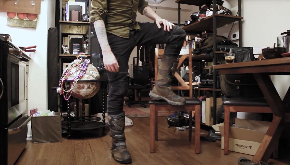 Standing rider showing full height of Forma Adventure Boots indoors with one foot on a chair