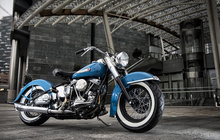 Blue cruiser motorcycle with Metzeler ME888 Marathon Ultra whitewall tires parked outdoors