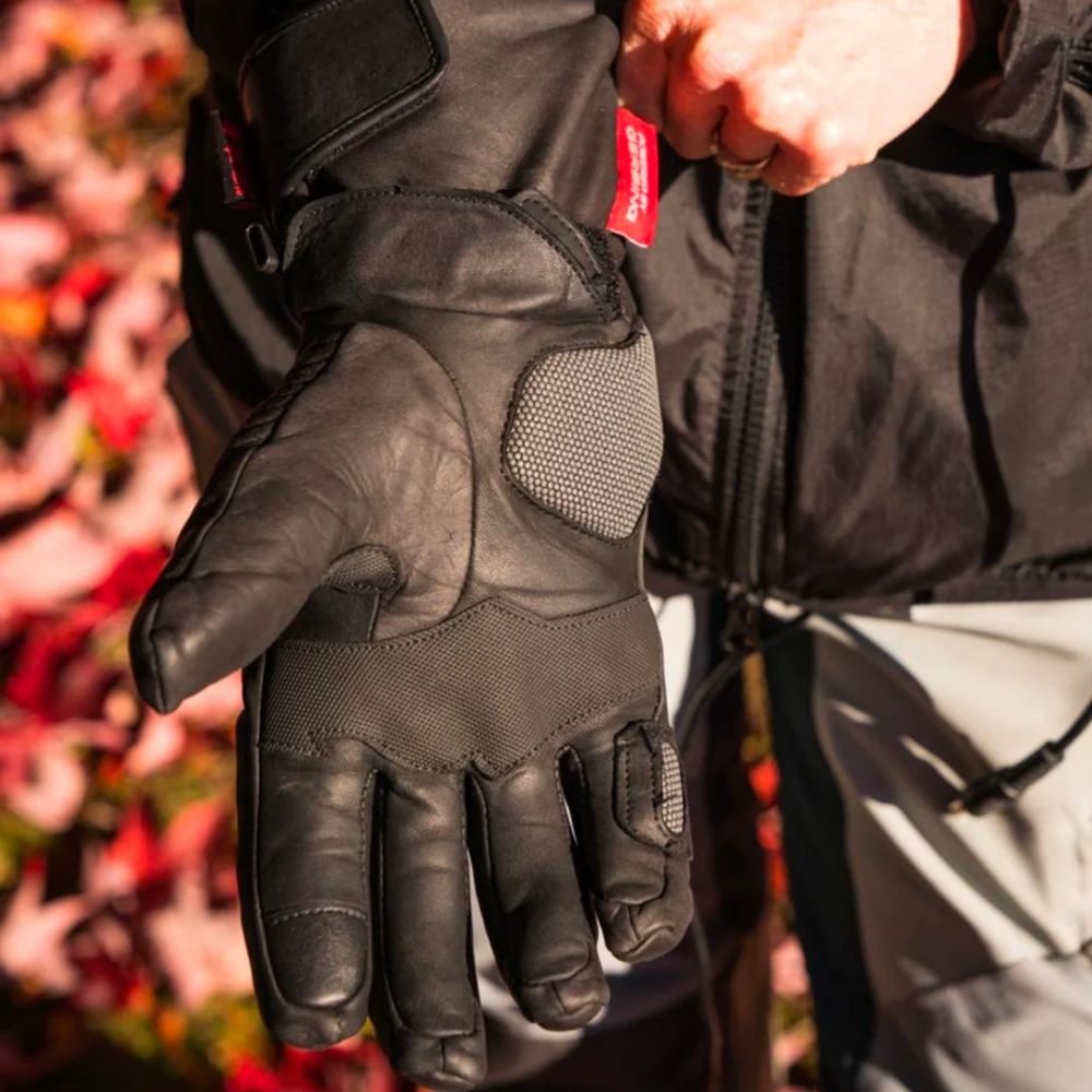 Close-up of a rider wearing heated motorcycle gloves showing detailed palm and wiring connection.