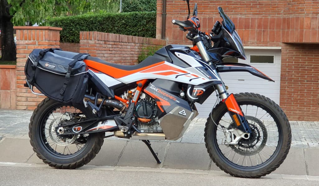 Adventure motorcycle equipped with soft panniers parked curbside