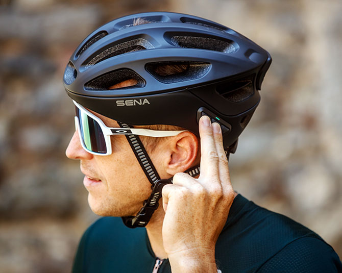 Cyclist using communication feature on the Sena R1 Evo Smart Helmet during a ride