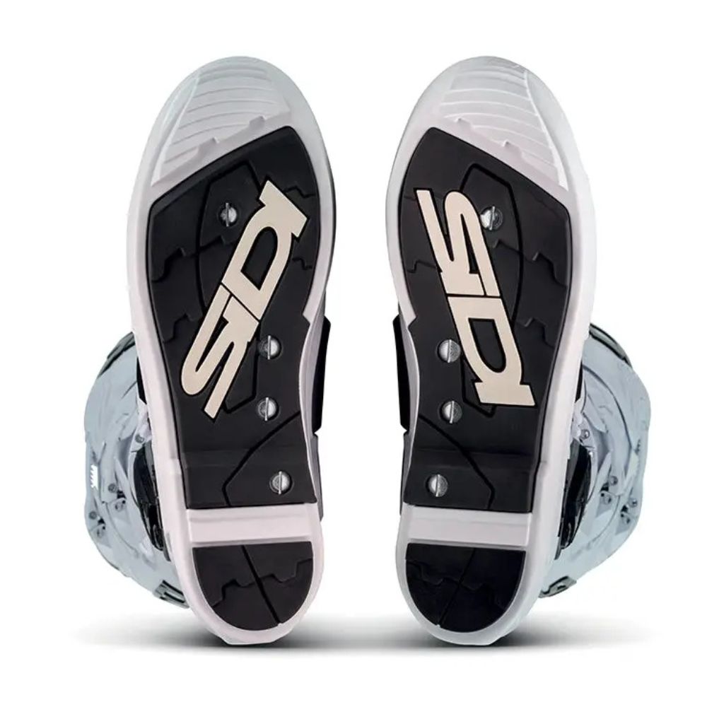 Bottom view of Sidi motocross boots with SRS (Sole Replacement System) showcasing smooth, replaceable sole inserts and minimal tread.