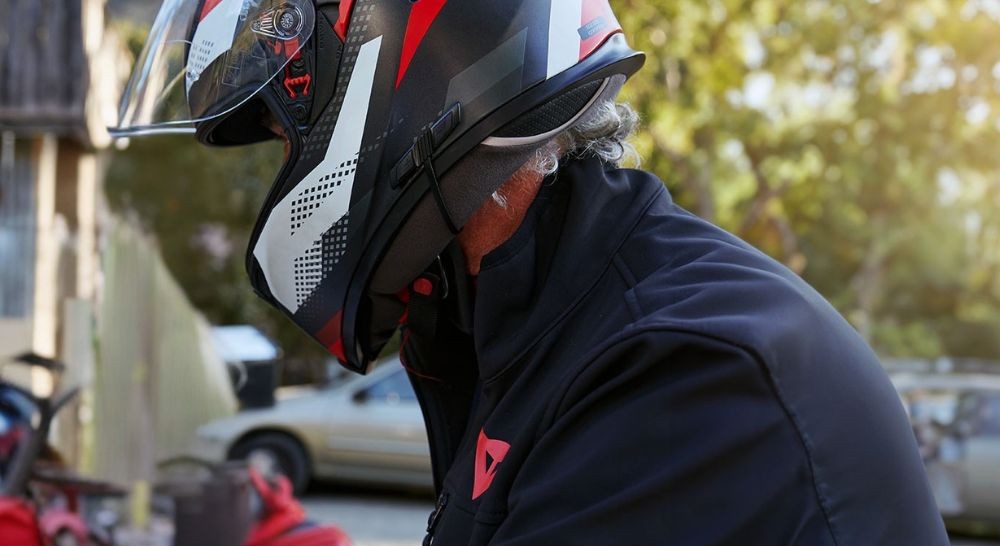 Motorcyclist in full-face helmet focused on the road, riding solo
