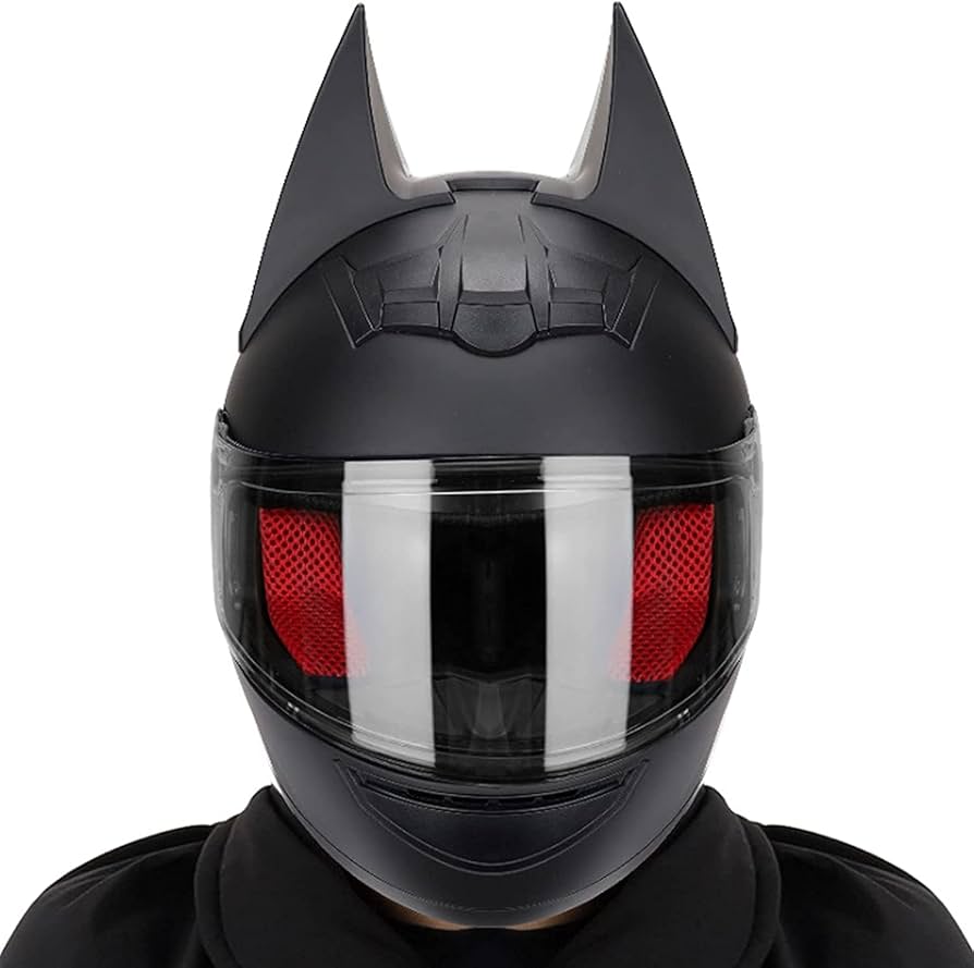 Front view of a novelty motorcycle helmet with bat ears and red interior padding, styled after Batman but lacking certified protection.