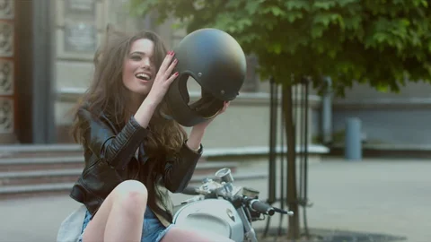 Woman laughing with messy hair after taking off helmet